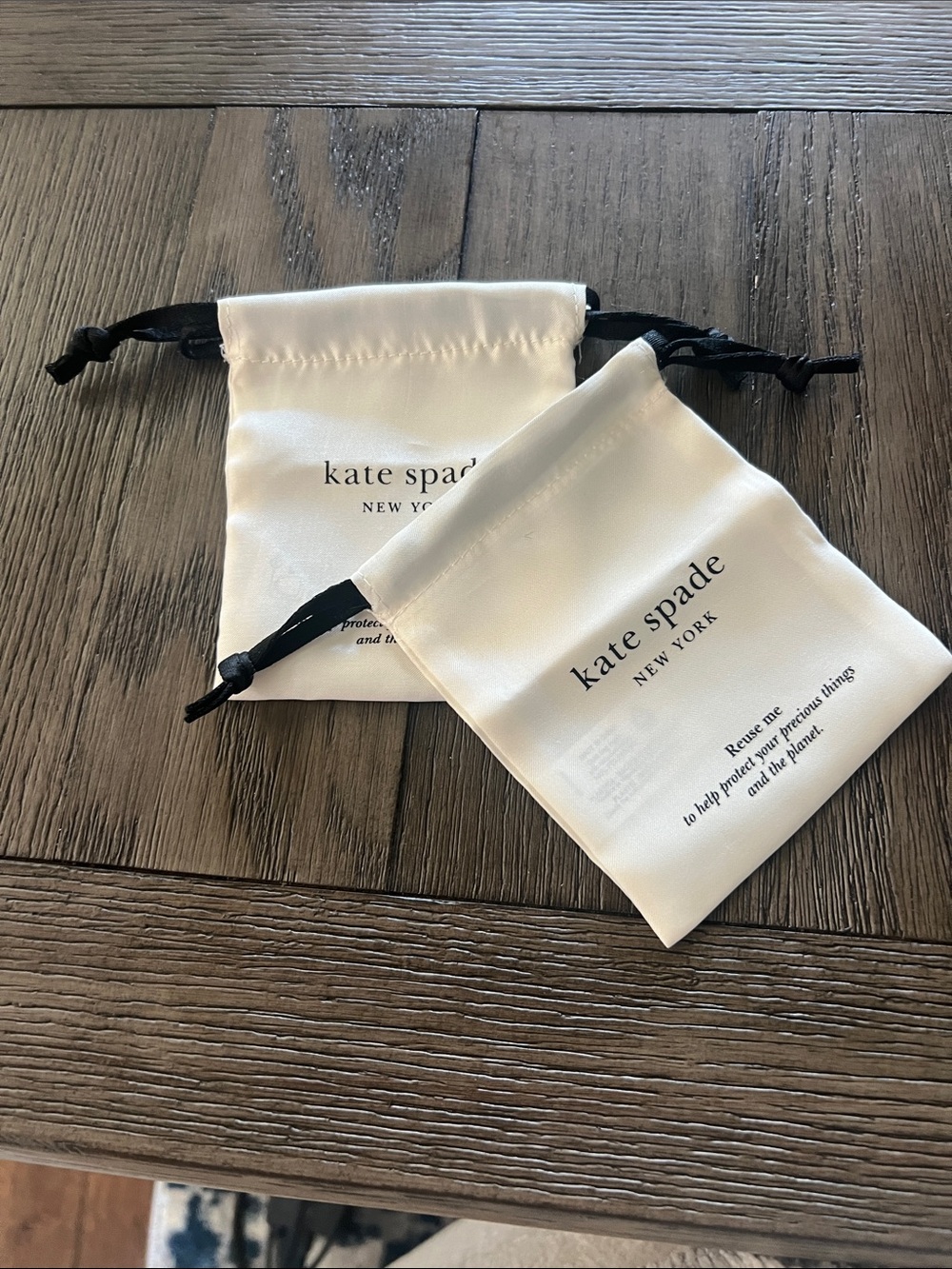 kate spade ivory and black drawstring mini pouches